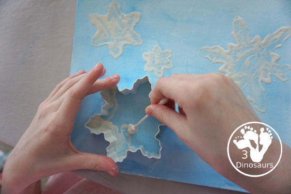 Snowflake Q-Tip Painting - a fun mixed art project that kids can do to paint snowflakes - 3Dinosaurs.com