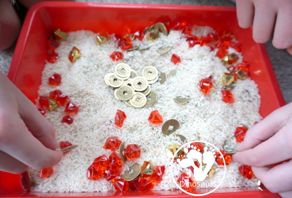Lunar New Year Sensory Bin - a fun sensory bin with rice, coins, and red rocks for a simple and easy to put together sensory bin for Chinese New year or Lunar New Year- 3Dinosaurs.com