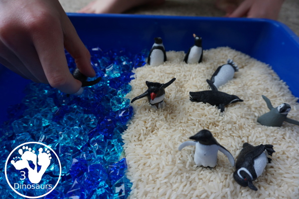 Penguin Rice Sensory Bin - with penguins, blue acrylic rocks and rice for a fun polar animal sensory bin that kids can play in. - 3Dinosaurs.com