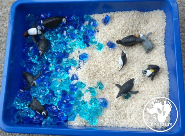 Penguin Rice Sensory Bin - with penguins, blue acrylic rocks and rice for a fun polar animal sensory bin that kids can play in. - 3Dinosaurs.com