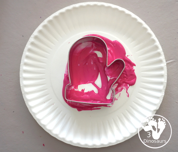 Mitten Cookie Cutter Stamp Painting - a simple winter painting that kids can do with a mitten cookie cutter. - 3Dinosaurs.com