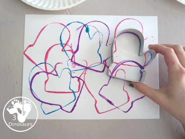 Mitten Cookie Cutter Stamp Painting - a simple winter painting that kids can do with a mitten cookie cutter. - 3Dinosaurs.com