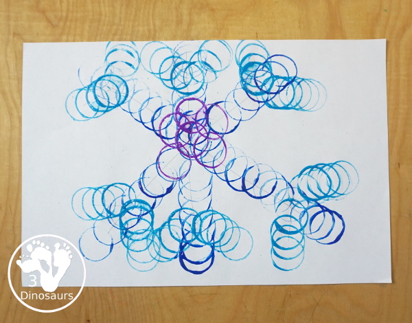 Paper Roll Painted Snowflake - a fun snowflake painting with blue and purple colors and using paper rolls to make the snowflakes. A simple and easy PreK and kindergarten craft for winter. - 3Dinosaurs.com