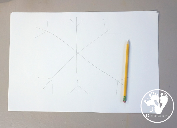 Paper Roll Painted Snowflake - a fun snowflake painting with blue and purple colors and using paper rolls to make the snowflakes. A simple and easy PreK and kindergarten craft for winter. - 3Dinosaurs.com
