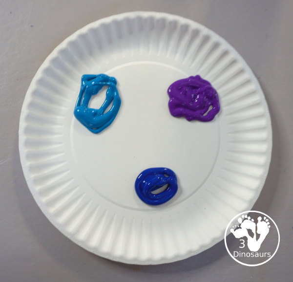 Paper Roll Painted Snowflake - a fun snowflake painting with blue and purple colors and using paper rolls to make the snowflakes. A simple and easy PreK and kindergarten craft for winter. - 3Dinosaurs.com