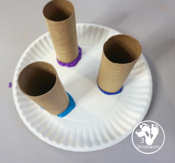 Paper Roll Painted Snowflake - a fun snowflake painting with blue and purple colors and using paper rolls to make the snowflakes. A simple and easy PreK and kindergarten craft for winter. - 3Dinosaurs.com