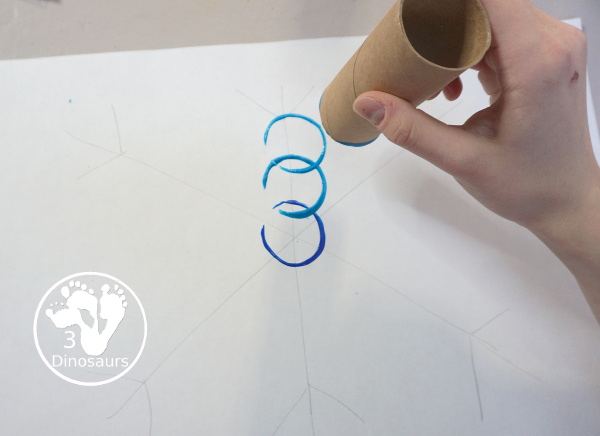 Paper Roll Painted Snowflake - a fun snowflake painting with blue and purple colors and using paper rolls to make the snowflakes. A simple and easy PreK and kindergarten craft for winter. - 3Dinosaurs.com