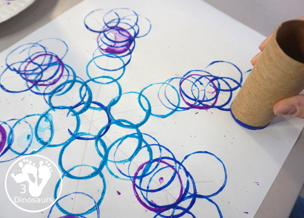 Paper Roll Painted Snowflake - a fun snowflake painting with blue and purple colors and using paper rolls to make the snowflakes. A simple and easy PreK and kindergarten craft for winter. - 3Dinosaurs.com