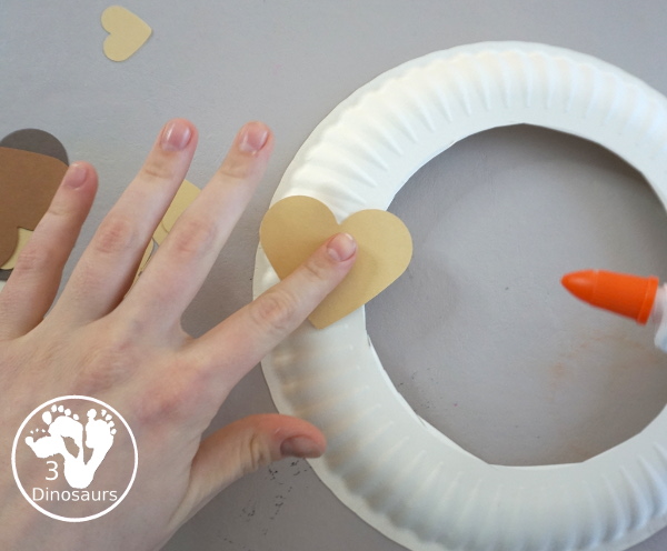 Black History Month Heart Wreath Craft - a simple wreath made with hearts of different shades of skin color for Black history month or Martin Luther King Jr Day. An easy craft to do with kids. - 3Dinosaurs.com