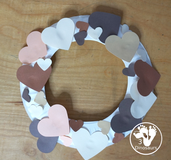 Black History Month Heart Wreath Craft - a simple wreath made with hearts of different shades of skin color for Black history month or Martin Luther King Jr Day. An easy craft to do with kids. - 3Dinosaurs.com