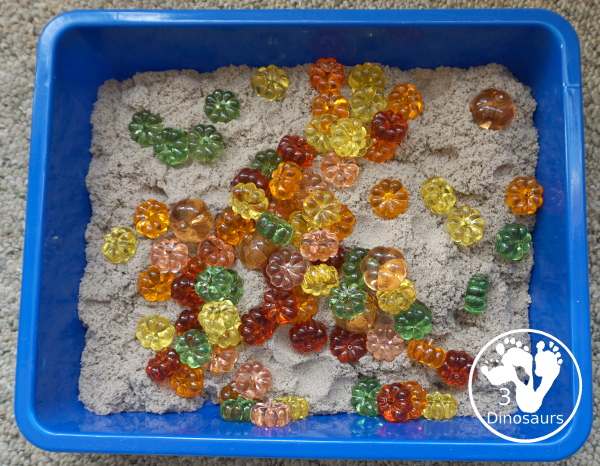 Pumpkin & Kinetic Sand Sensory Bin - a simple and easy fall sensory bin with pumpkins and kinetic sand for kids to play in. - 3Dinosaurs.com