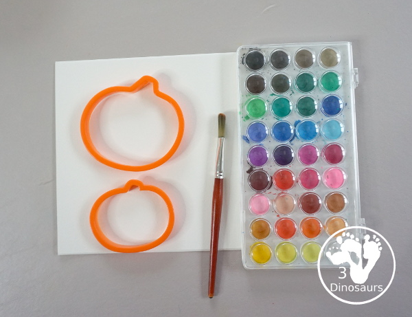 Pumpkin Cookie Cutter Watercolor Painting - a fun watercolor painting activity with pumpkin cookie cutters to make the pumpkins. Simple pumpkin paintings that different ages can do. - 3Dinosaurs.com