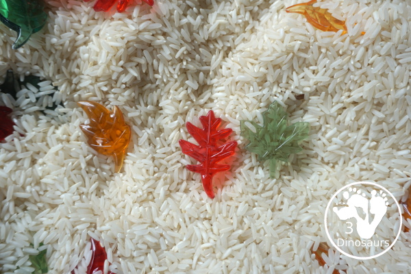 Fall Leaves Sensory Bin - a simple fall leaf sensory bin with different colors of leaves with red, yellow, orange, and green leaves. The sensory bin as a rice filler. - 3Dinosaurs.com