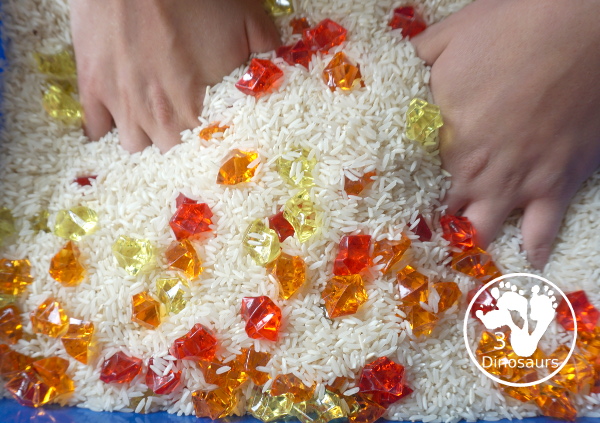 Red Yellow & Orange Sensory Bin - a fun fall color sensory bin. It is super simple to set up and easy for kids to explore the colors. - 3Dinosaurs.com