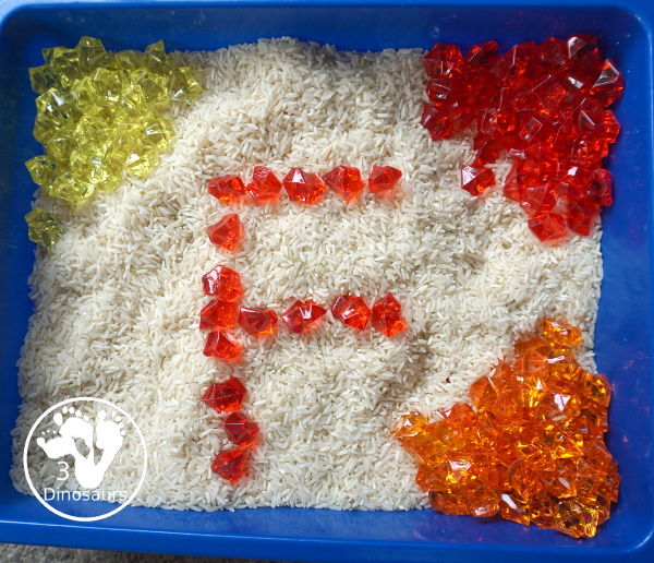 Red Yellow & Orange Sensory Bin - a fun fall color sensory bin. It is super simple to set up and easy for kids to explore the colors. - 3Dinosaurs.com