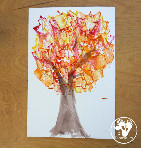 Fall Tree Scrape Painting with Leaf Cookie Cutters - a simple watercolor trunk and branches with leaf cookie cutter scrape painting. A great fall tree craft for kids. 3Dinosaurs.com