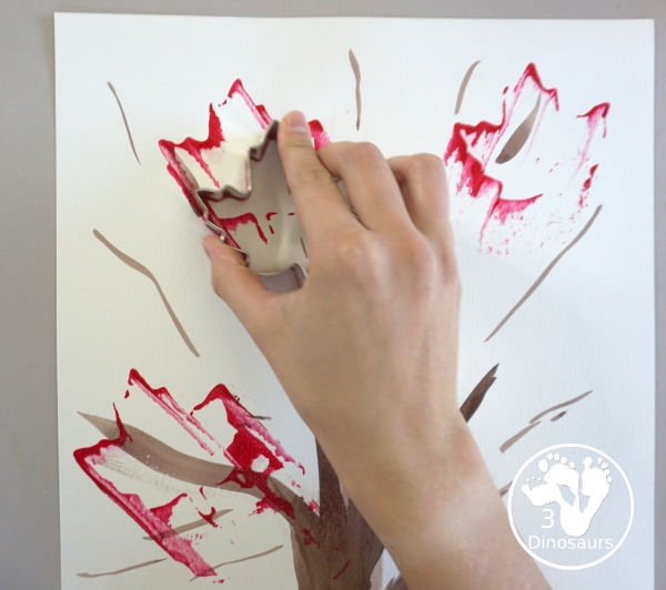 Fall Tree Scrape Painting with Leaf Cookie Cutters - a simple watercolor trunk and branches with leaf cookie cutter scrape painting. A great fall tree craft for kids. 3Dinosaurs.com
