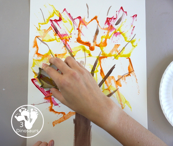 Fall Tree Scrape Painting with Leaf Cookie Cutters - a simple watercolor trunk and branches with leaf cookie cutter scrape painting. A great fall tree craft for kids. 3Dinosaurs.com