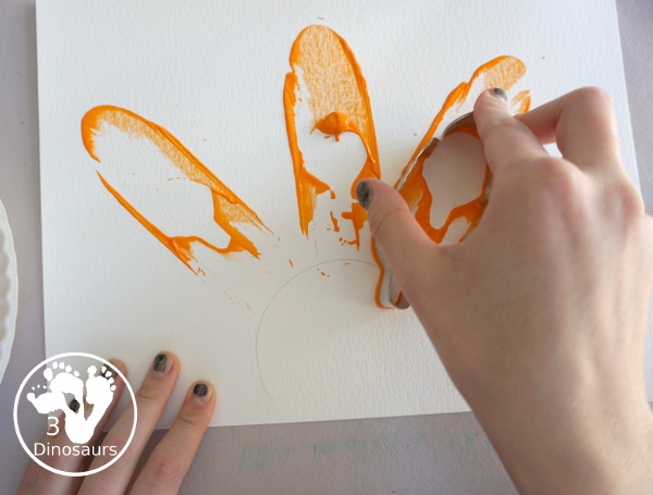 Turkey Feather Scrap Painting for Kids - a fun turkey craft made with a cookie cutter feather and construction paper. A fun painting idea with feathers for a Thanksgiving craft for kids in preschool, prek, and kindergarten. 3Dinosaurs.com