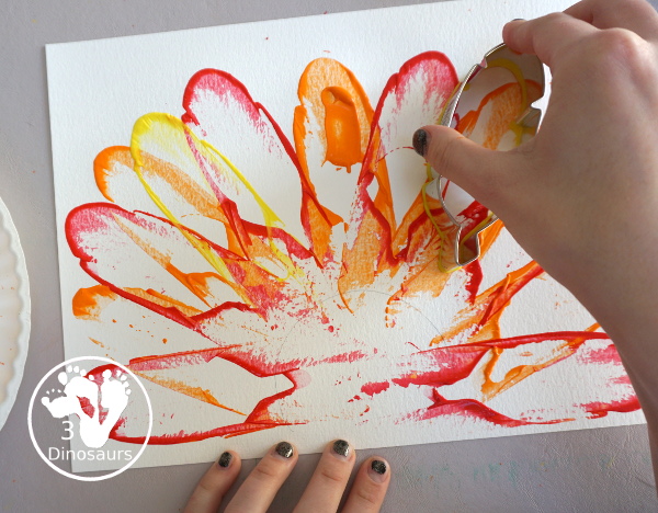 Turkey Feather Scrap Painting for Kids - a fun turkey craft made with a cookie cutter feather and construction paper. A fun painting idea with feathers for a Thanksgiving craft for kids in preschool, prek, and kindergarten. 3Dinosaurs.com