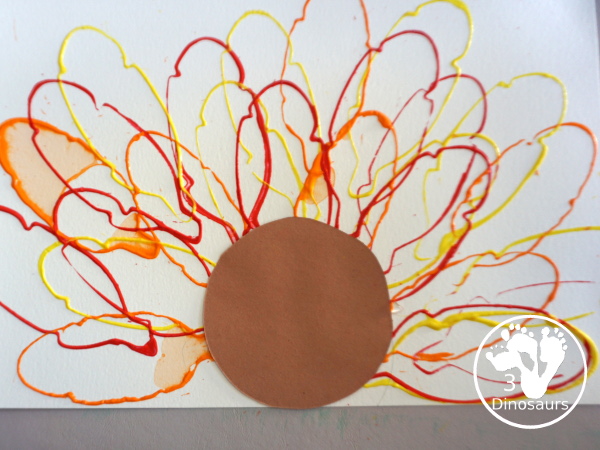 Turkey Feather Stamp Painting for Kids - a fun turkey craft made with a cookie cutter feather and construction paper. A fun idea for a Thanksgiving craft for kids in preschool, prek, and kindergarten. 3Dinosaurs.com