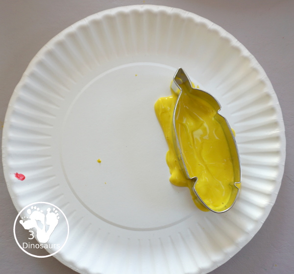 Turkey Feather Stamp Painting for Kids - a fun turkey craft made with a cookie cutter feather and construction paper. A fun idea for a Thanksgiving craft for kids in preschool, prek, and kindergarten. 3Dinosaurs.com