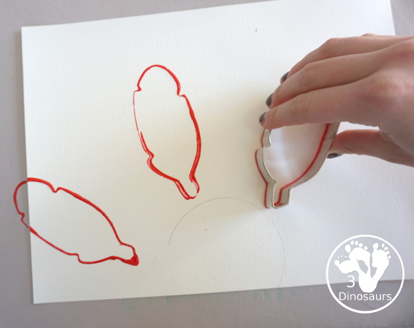 Turkey Feather Stamp Painting for Kids - a fun turkey craft made with a cookie cutter feather and construction paper. A fun idea for a Thanksgiving craft for kids in preschool, prek, and kindergarten. 3Dinosaurs.com