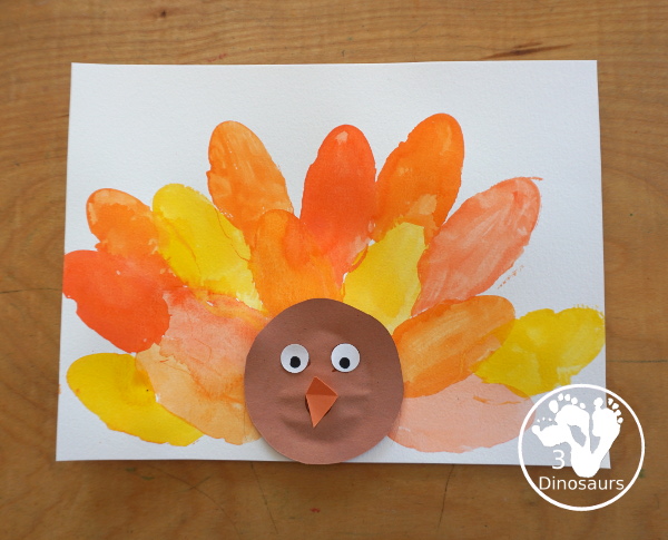 Turkey Feather Watercolor Painting for Kids - a fun turkey craft made with a cookie cutter feather and construction paper. A fun watercolor painting idea with feathers for a Thanksgiving craft for kids in preschool, prek, and kindergarten. 3Dinosaurs.co