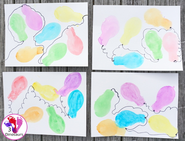Easy to do Glitter Watercolor Christmas Lights Painting - using glitter watercolors and cookie cutters is easy to have different ages work together on a fun painting activity - 3Dinosaurs.com