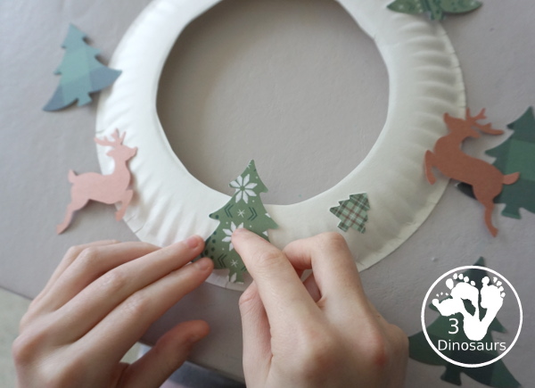 Reindeer Christmas Wreath Craft - a super easy wreath made with reindeer punches and tree punches that kids can make - 3Dinosaurs.com