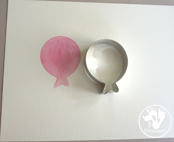 Balloon Watercolor Painting with Cookie Cutters - a simple watercolor painting with a balloon cookie cutter that kids of all ages can do for a party or New Year's Eve - 3Dinosaurs.com