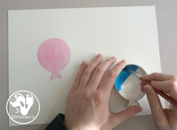 Balloon Watercolor Painting with Cookie Cutters - a simple watercolor painting with a balloon cookie cutter that kids of all ages can do for a party or New Year's Eve - 3Dinosaurs.com