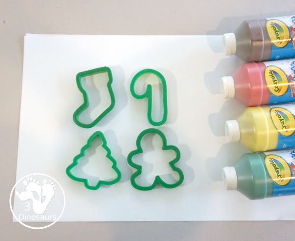 Christmas Cookie Cutter Painting - You stamp cookie cutters on the paper with each cookie cutter having a different color - 3Dinosaurs.com