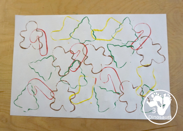 Christmas Cookie Cutter Painting - You stamp cookie cutters on the paper with each cookie cutter having a different color - 3Dinosaurs.com