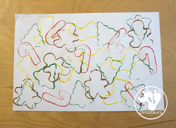 Christmas Cookie Cutter Painting - You stamp cookie cutters on the paper with each cookie cutter having a different color - 3Dinosaurs.com