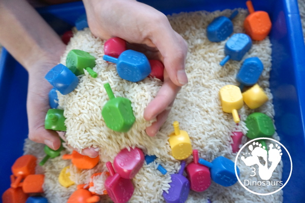 Dreidel Sensory Bin with Rice for Hanukkah - A simple Hanukkah sensory bin with dreidels and rice for the sensory bin - 3Dinosaurs.com