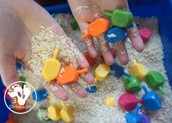 Dreidel Sensory Bin with Rice for Hanukkah - A simple Hanukkah sensory bin with dreidels and rice for the sensory bin - 3Dinosaurs.com