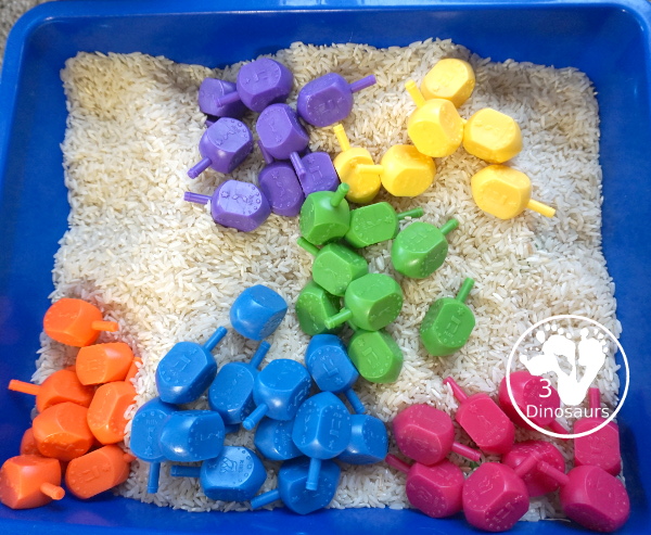 Dreidel Sensory Bin with Rice for Hanukkah - A simple Hanukkah sensory bin with dreidels and rice for the sensory bin - 3Dinosaurs.com