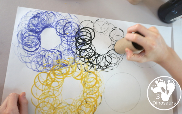 Paper Roll Olympic Rings Painting - an easy Olympic craft that you can use with kids to make an Olympic flag - 3Dinosaurs.com