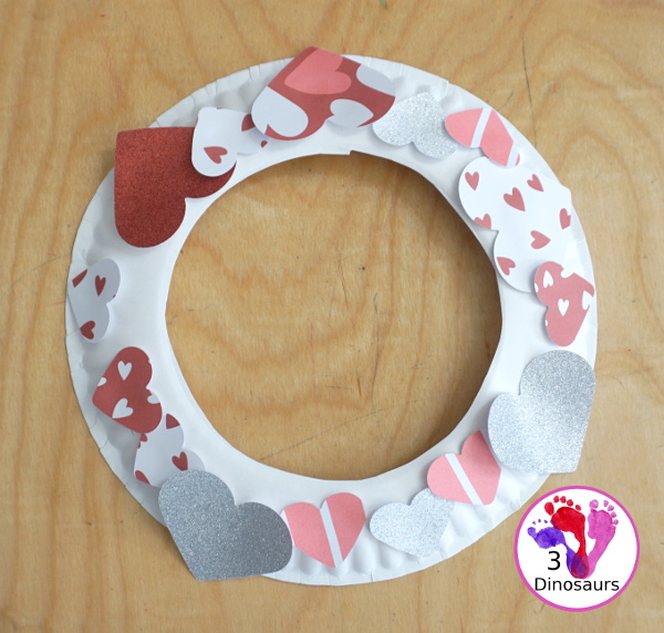Valentines Heart Wreaths with Scrapbook Paper a fun paper plate wreath made using a heart punch and loads of fun for Valentines Day - 3Dinosaurs.com