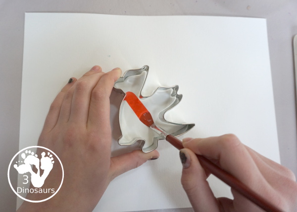 Dragon Watercolor Painting with rainbow color dragons made with a dragon cookie cutter and watercolor paints. A simple painting activity for different ages- 3Dinosaurs.com