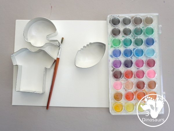 Football Cookie Cutter Watercolor Painting - a fun painting that kids can do with a football theme. A great way to do a fun watercolor painting is by different football team colors. - 3Dinosaurs.com