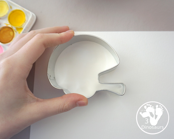 Football Cookie Cutter Watercolor Painting - a fun painting that kids can do with a football theme. A great way to do a fun watercolor painting is by different football team colors. - 3Dinosaurs.com