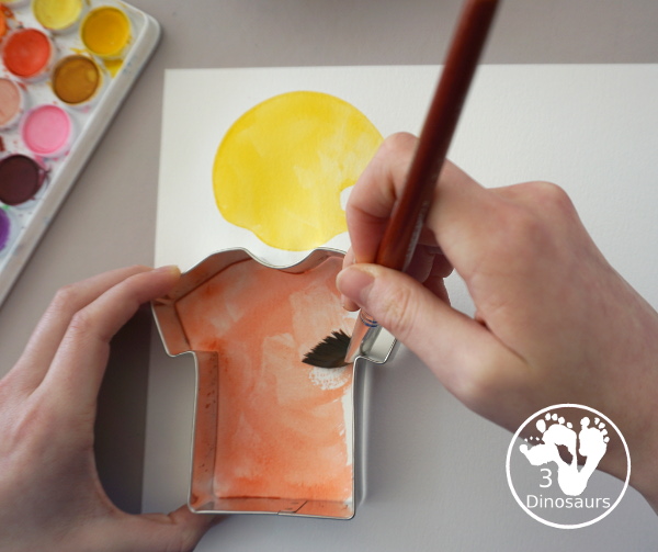 Football Cookie Cutter Watercolor Painting - a fun painting that kids can do with a football theme. A great way to do a fun watercolor painting is by different football team colors. - 3Dinosaurs.com