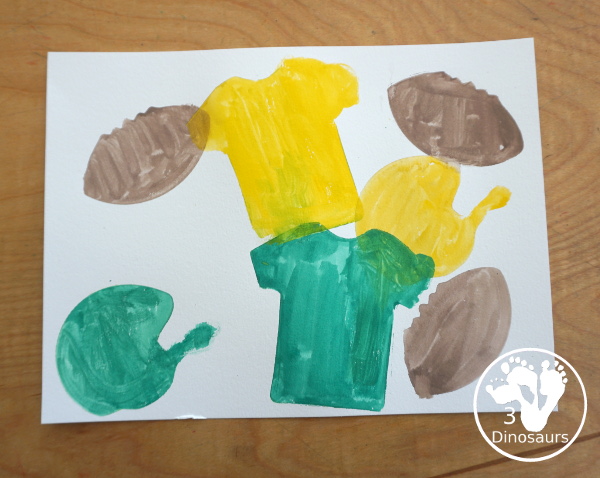 Football Cookie Cutter Watercolor Painting - a fun painting that kids can do with a football theme. A great way to do a fun watercolor painting is by different football team colors. - 3Dinosaurs.com