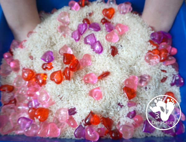 Heart Rice Sensory Bin For Kids - acrylic hearts in a rice sensory bin that you can use with kids during Valentines or a heart shape theme. - 3Dinosaurs.com