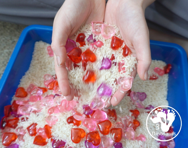 Heart Rice Sensory Bin For Kids - acrylic hearts in a rice sensory bin that you can use with kids during Valentines or a heart shape theme. - 3Dinosaurs.com
