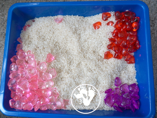 Heart Rice Sensory Bin For Kids - acrylic hearts in a rice sensory bin that you can use with kids during Valentines or a heart shape theme. - 3Dinosaurs.com