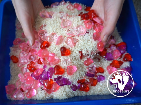 Heart Rice Sensory Bin For Kids - acrylic hearts in a rice sensory bin that you can use with kids during Valentines or a heart shape theme. - 3Dinosaurs.com