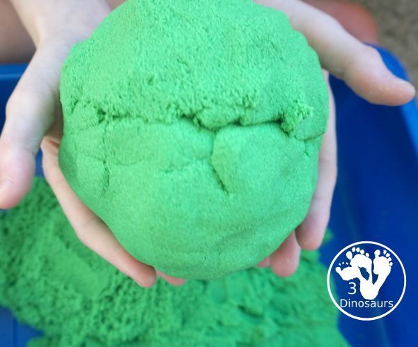 St. Patrick's Day Gold Find Sensory Bin - a fun kinetic sand sensory bin for St. Patrick's Day with finding the gold in the sensory bin - 3Dinosaurs.com